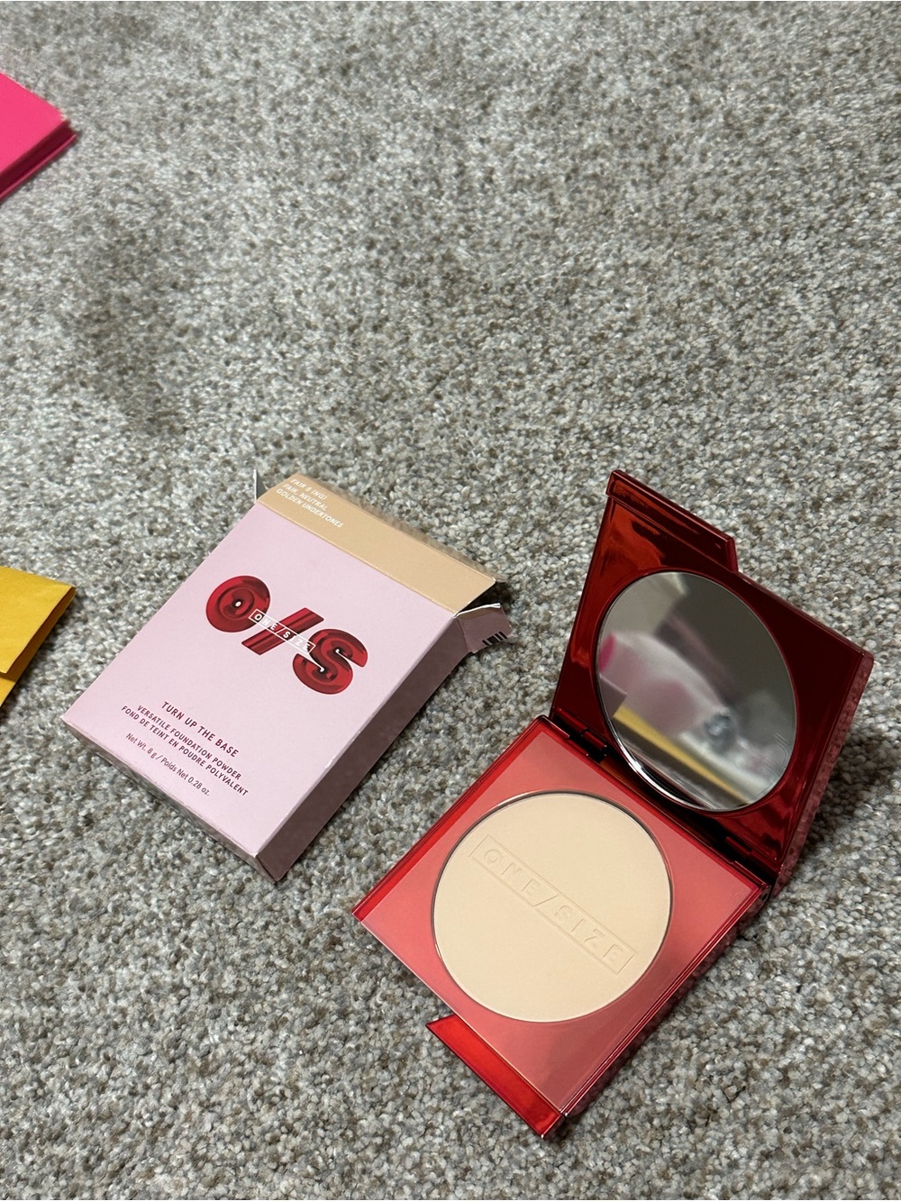 Glossier pressed setting powder compact in cream with red case